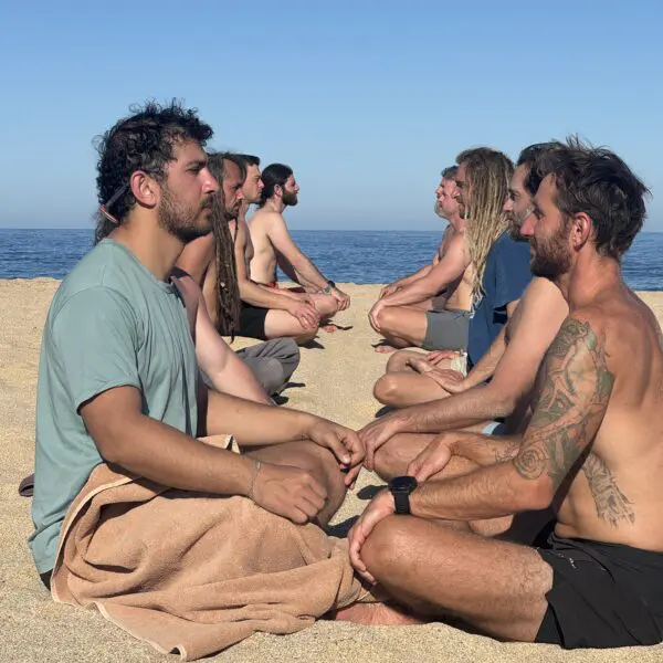 Men staring at one another doing breathwork